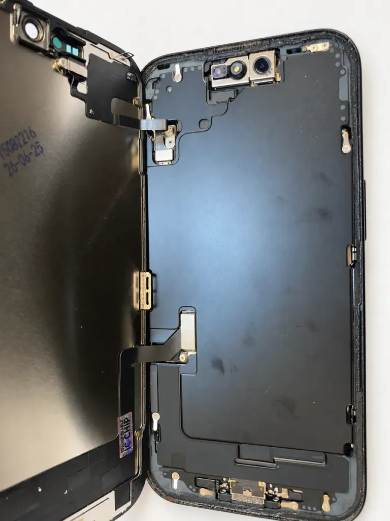 Replacement iPhone 15 display and sensor cables connected to the device